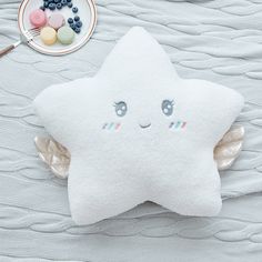 a white star shaped pillow sitting on top of a table