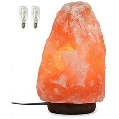 an orange himalayan salt lamp with two lights on each side and one light on the other