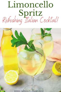 two glasses filled with lemonade and mint spritz on top of a table