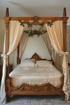 a canopy bed with white sheets and curtains