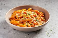 a white bowl filled with pasta covered in parmesan cheese