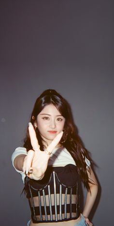 a young woman making the v sign with her fingers