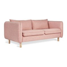 a pink couch with wooden legs on a white background