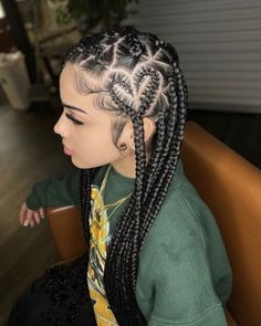 a woman with long braids sitting in a chair