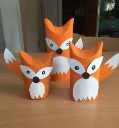 four paper cups that have been made to look like foxes