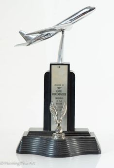 an award is placed on top of a black base with a silver eagle statue in the center