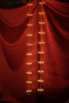 a red curtain with lights hanging from it