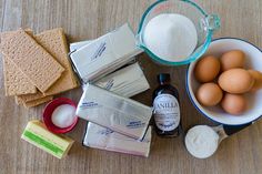 ingredients to make cookies laid out on a wooden table with flour, butter and eggs