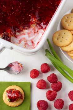 raspberry cheesecake dip with crackers and fresh raspberries on the side