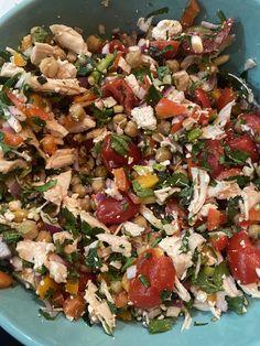 a blue bowl filled with lots of different types of food