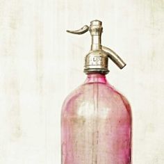 a pink glass bottle with a silver faucet on it and a bible verse