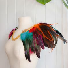 A one-off, hand-made, feather collar that sits over the shoulders and fastens at the front with a gold-coloured necklace. This collar has multiple layers of feathers in shades of burgundy, purple, blue, yellow, green, and black, plus a delicate gold trim that sits around the neckline. It will add extra flair to your outfit, whether that is for a special occasion, Halloween party, festival, performance, or just doing the housework!  This collar is comfortable to wear and should fit most neck size Warrior Makeup, Feather Collar, Viking Braids, Shades Of Burgundy, Bib Collar, Decorative Trim, Party Festival, A Necklace, Fete Halloween