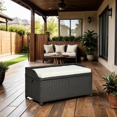 an outdoor living room with wooden floors and furniture