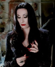 a woman with long black hair and red nails