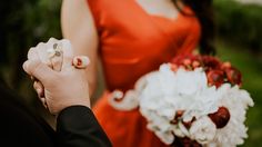 the bride and groom are holding hands with their wedding rings on their fingernails