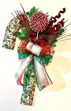 a christmas decoration with candy canes and greenery