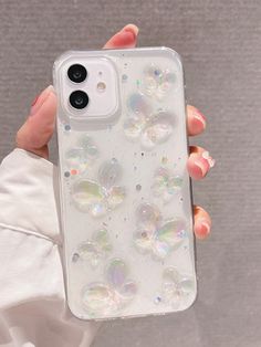 a person holding up a phone case with bubbles on it