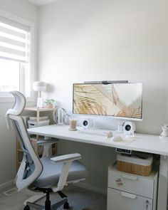 a desk with a computer monitor and speakers on it