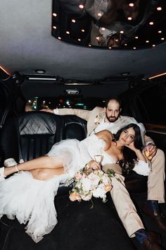 a bride and groom sitting in the back of a limo with their feet on the floor