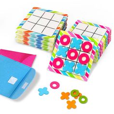 several pieces of colorful fabric and buttons on a white surface, including an origami box