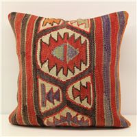 a colorful decorative pillow on a white surface