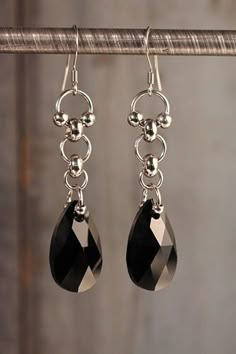 "Stainless steel dangle earrings with jet black, Austrian crystal by Swarovski. Sturdy for everyday wear, but elegant as they shine and swing with every movement. Approximately 2\" long and .5\" inches wide." Black Chandelier Earrings As Gift, Diy Earrings Dangle, Chainmail Earrings, Wire Wrap Jewelry Designs, Chainmail Jewelry, Bijoux Fil Aluminium, Aluminum Jewelry, Diy Jewelry Projects, Chain Maille Jewelry