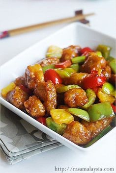 a white bowl filled with meat and vegetables