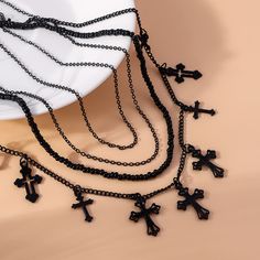 ✦ Elevate your style with our Cool Dark Cross Layering Grunge Necklace Statement! This unique necklace features multiple cross pendants on a sleek black chain, perfect for adding a touch of mystery and cool to any outfit. Whether you're dressing up for a costume party or simply want to make a statement, our necklace is a must-have for modern teens and adults. Each cross design is different, making this piece truly one-of-a-kind. Who says you need an occasion to flaunt this edgy jewelry? ----------- DETAILS ----------- Color: Black Necklace Length From Outer to Inner: 52cm; 52cm, 47cm; 42cm Pendant Length: 1.3-1.6cm Materials: Copper, Alloy - SKU: X0872 Gift Black Cross Necklace With Chain, Black Cross Necklace With Chain As Gift, Black Cross Chain Necklace As Gift, Black Cross Pendant Jewelry For Halloween, Gift Black Cross Chain Necklace, Edgy Black Chain Necklace For Gifts, Black Cross Chain Necklace Gift, Black Gothic Chain Necklace Gift, Trendy Black Cross Jewelry