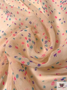 an image of a white fabric with multicolored spots