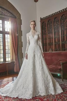 a woman in a wedding dress standing on a rug