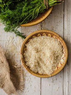 two bowls filled with rice next to each other on top of a white wooden table