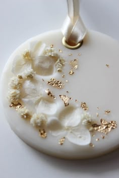 a white ornament with gold flakes on it