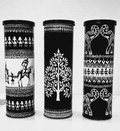 three black and white vases with designs on them