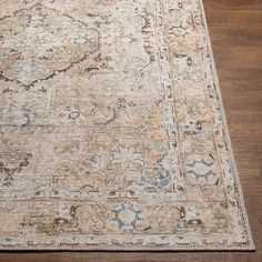 an antique rug on a wooden floor with a brown and blue border around the area