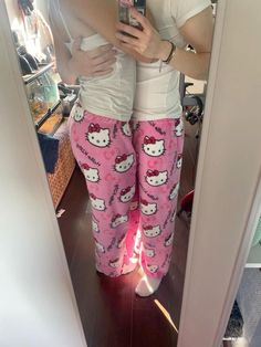 a woman taking a selfie in her hello kitty pajama pants