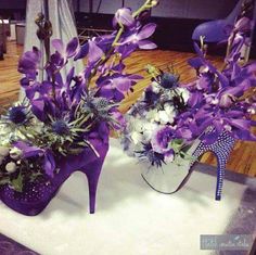 two purple high heeled shoes with flowers in them