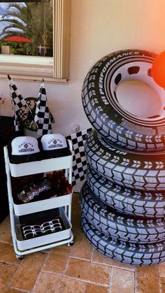 a stack of tires sitting next to each other on top of a tiled floor near a window