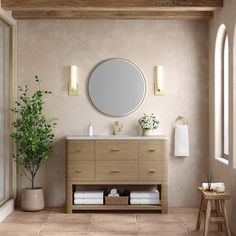 a bathroom with a sink, mirror and potted plant on the side table in front of it