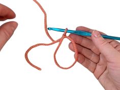 two hands holding an orange string and a blue crochet hook