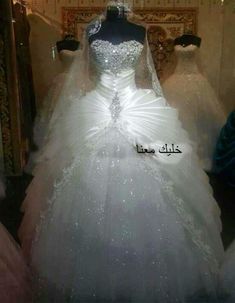 a white wedding dress on display in a store