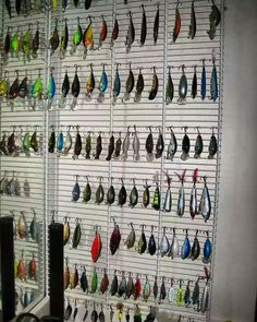 there are many different types of earrings hanging on the wall next to eachother