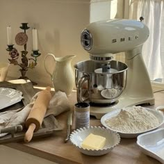 a kitchen counter topped with lots of different types of baking supplies and utensils