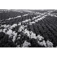 a black and white rug with an abstract design