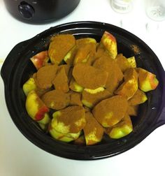 there are many pieces of food in the bowl on the table next to an air fryer