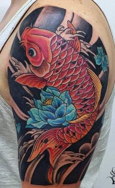 a man with a tattoo on his arm that has a koi fish in it