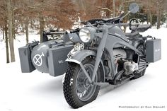 an old motorcycle is parked in the snow