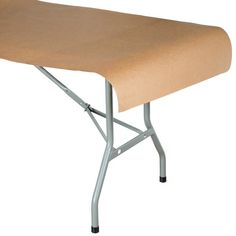 a table that has a brown cloth on the top and metal legs, with a white background