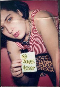 a woman holding up a sign that says go stone's never on her chest