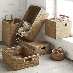 wicker baskets with handles and lids on the floor