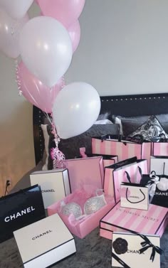 a bunch of pink and white boxes with balloons